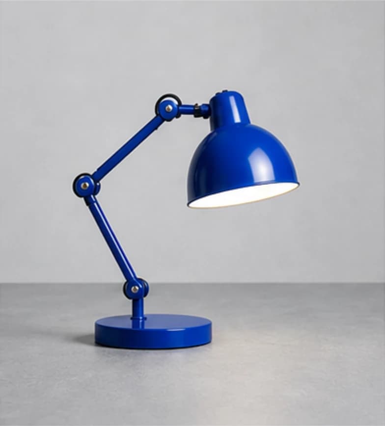 Cobalt articulated task lamp on a cool gray studio surface